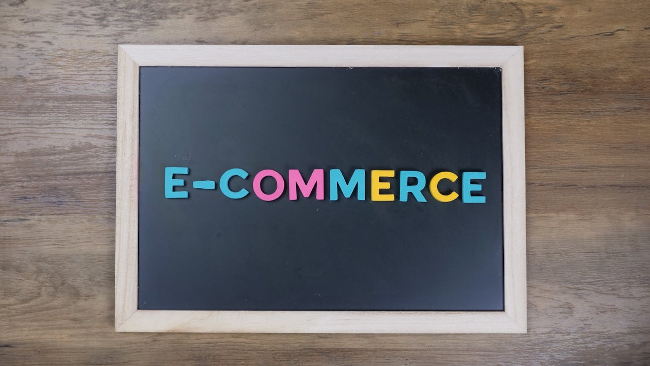 services-02 Colorful letters spelling e-commerce on a wooden framed blackboard.